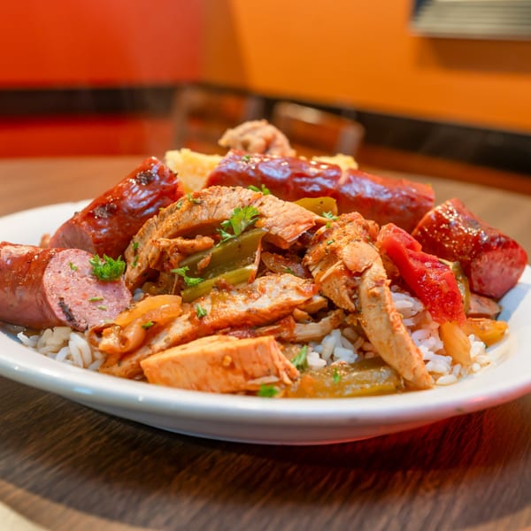 Southern-style jambalaya with chicken, sausage, peppers, and rice, garnished with parsley.